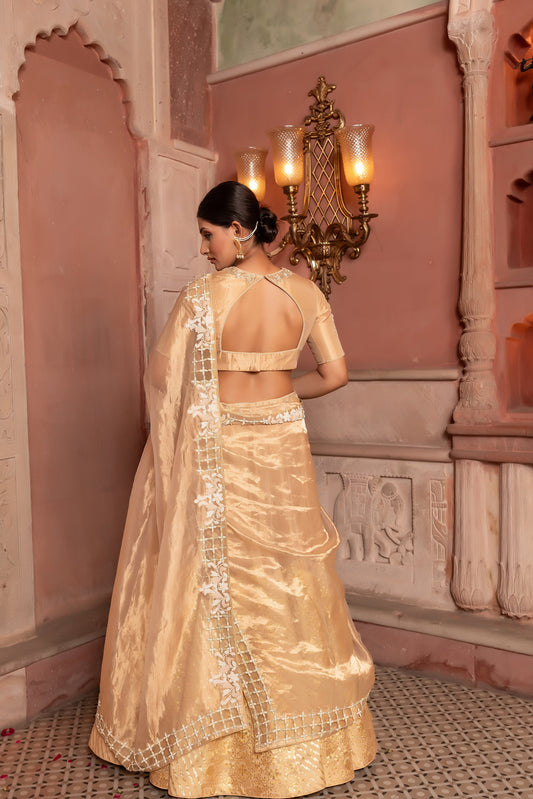 Luxury Golden Tissue Lehenga Choli with Intricate Embellishments and Cutwork Dupatta