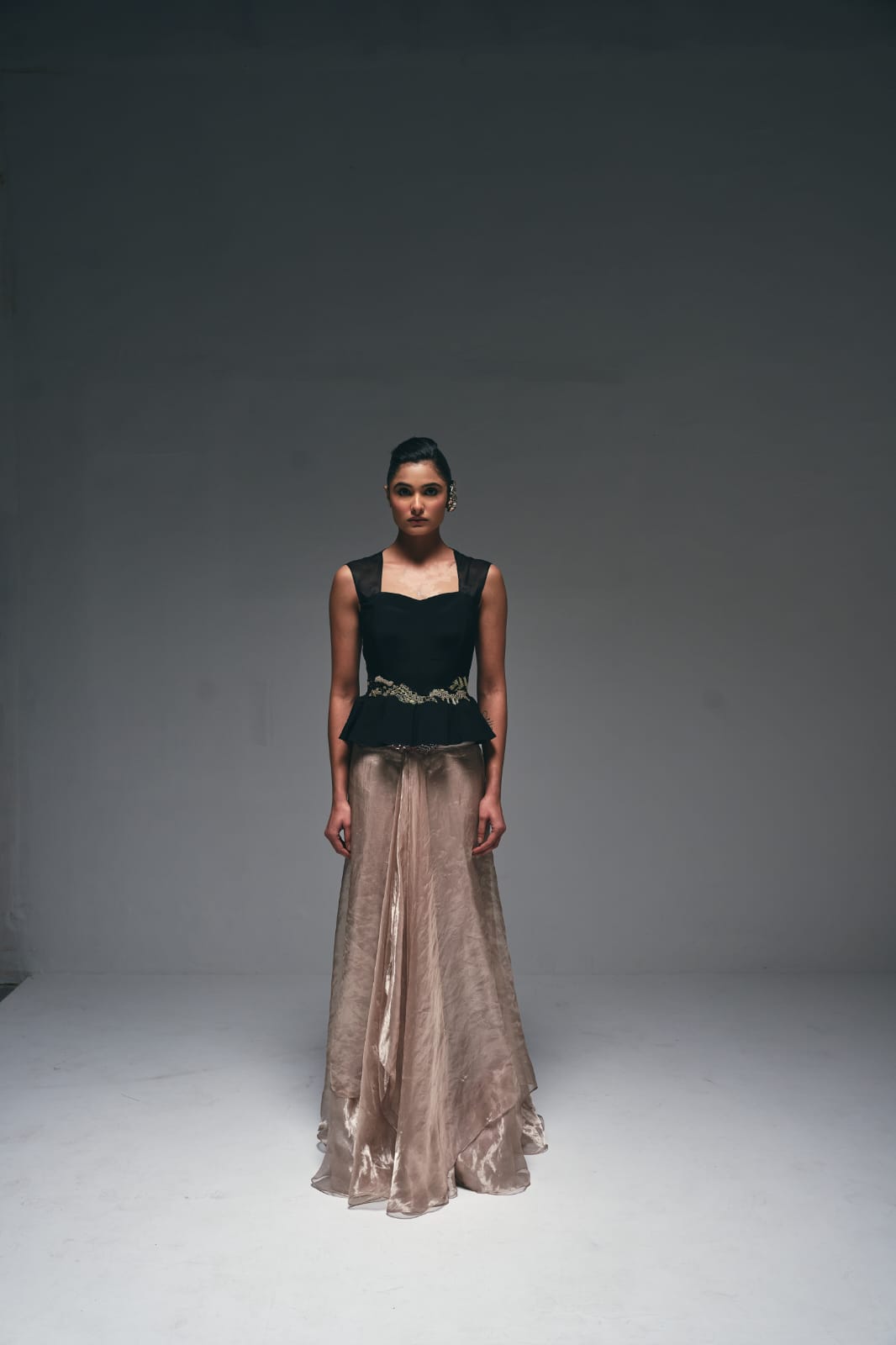 Crepe peplum top paired with a tissue drape skirt,