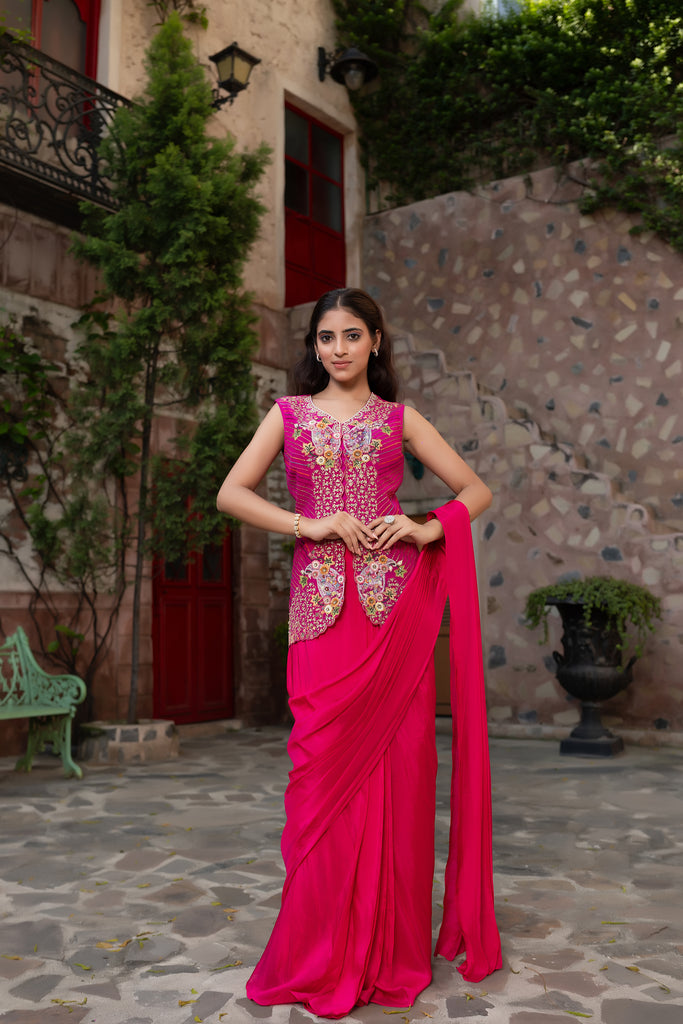Magenta drape saree with embroidered jacket .
