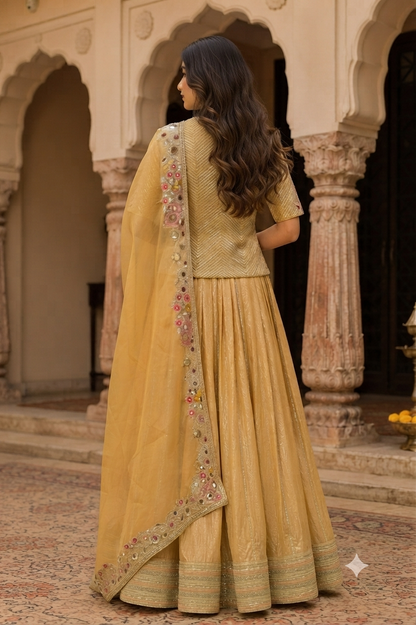 Mustard-gold/yellow lehenga saree with a subtle textured and lustrous finish throughout.
