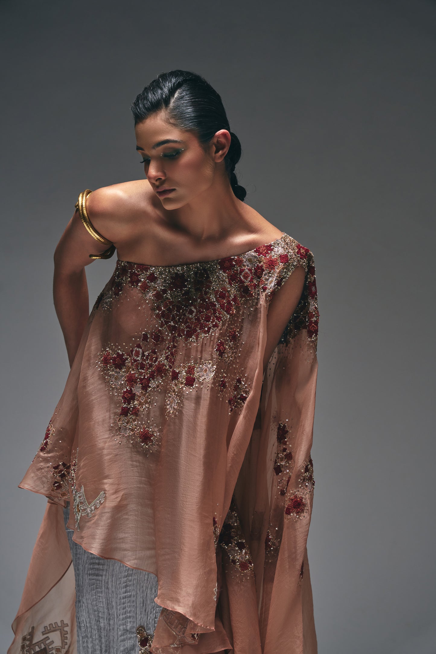 Organza one-shoulder asymmetrical cape paired with a crushed satin pencil skirt