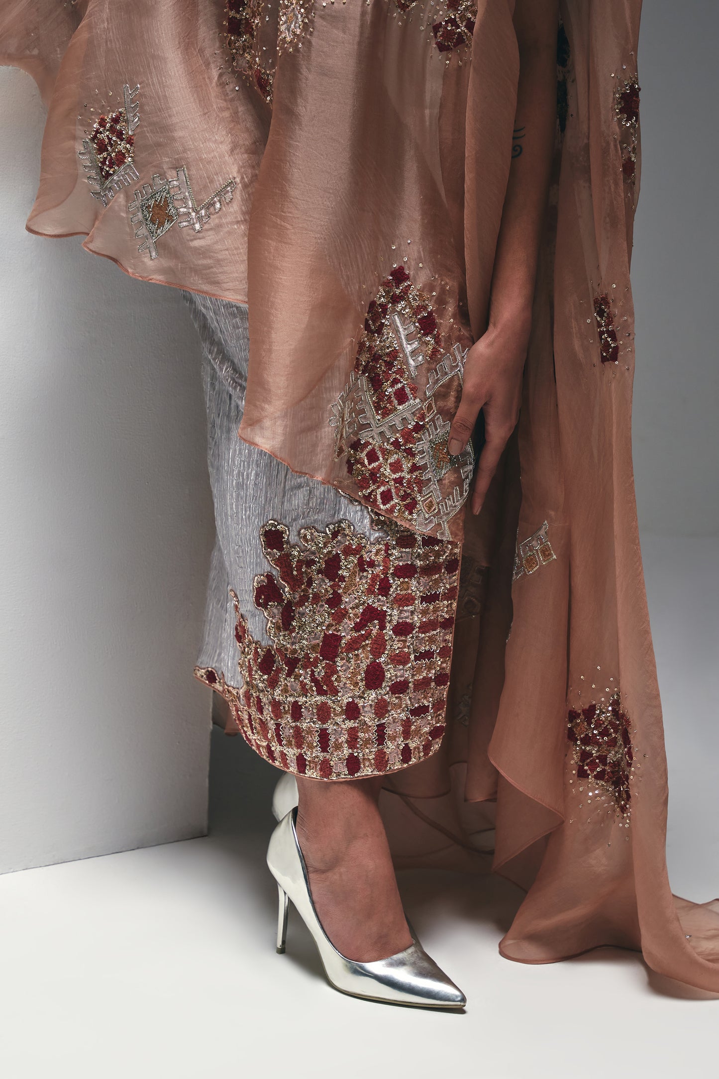 Organza one-shoulder asymmetrical cape paired with a crushed satin pencil skirt