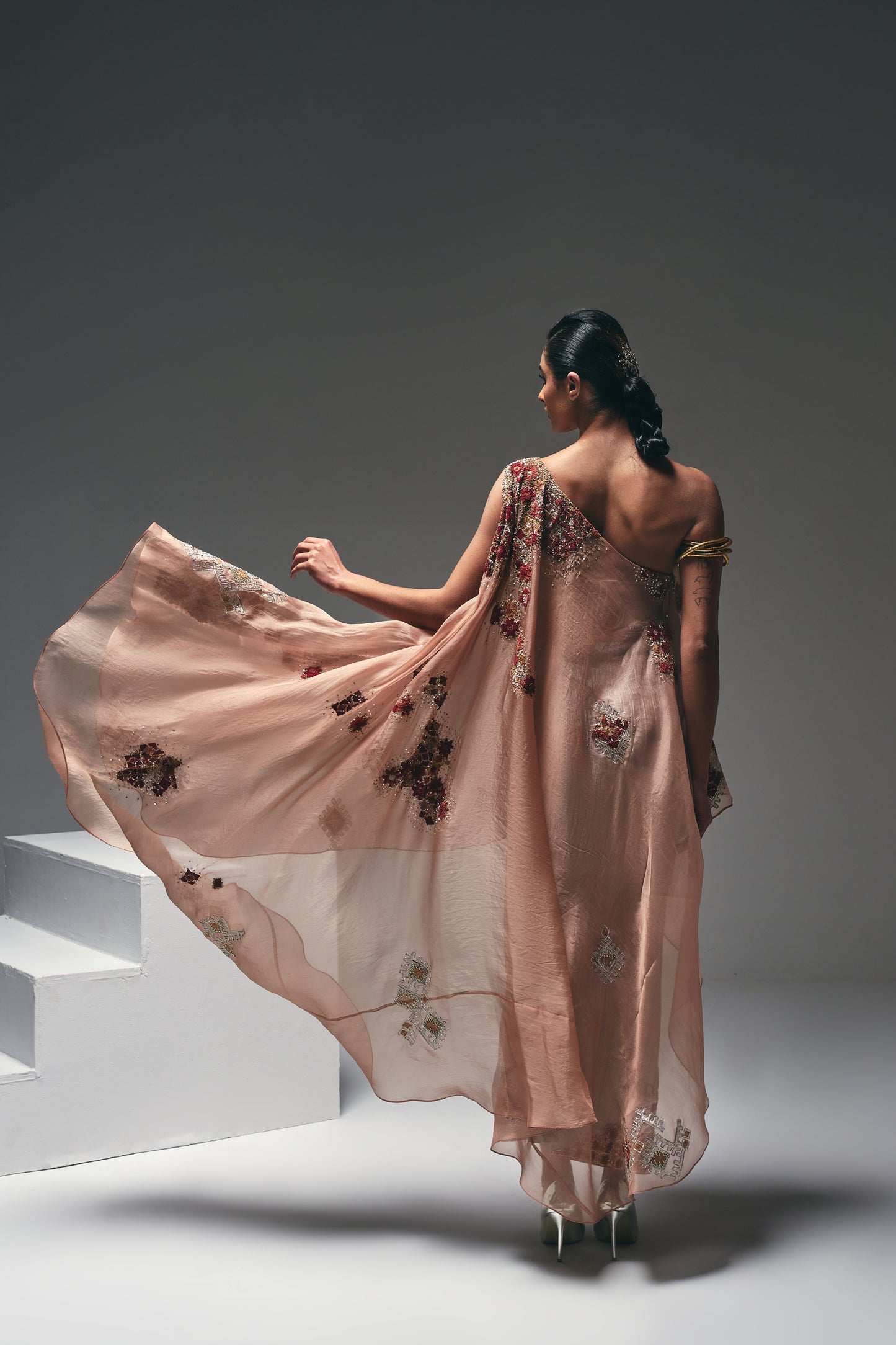 Organza one-shoulder asymmetrical cape paired with a crushed satin pencil skirt