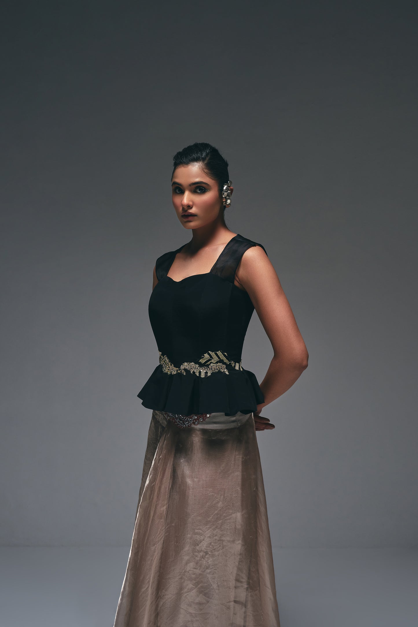 Crepe peplum top paired with a tissue drape skirt,