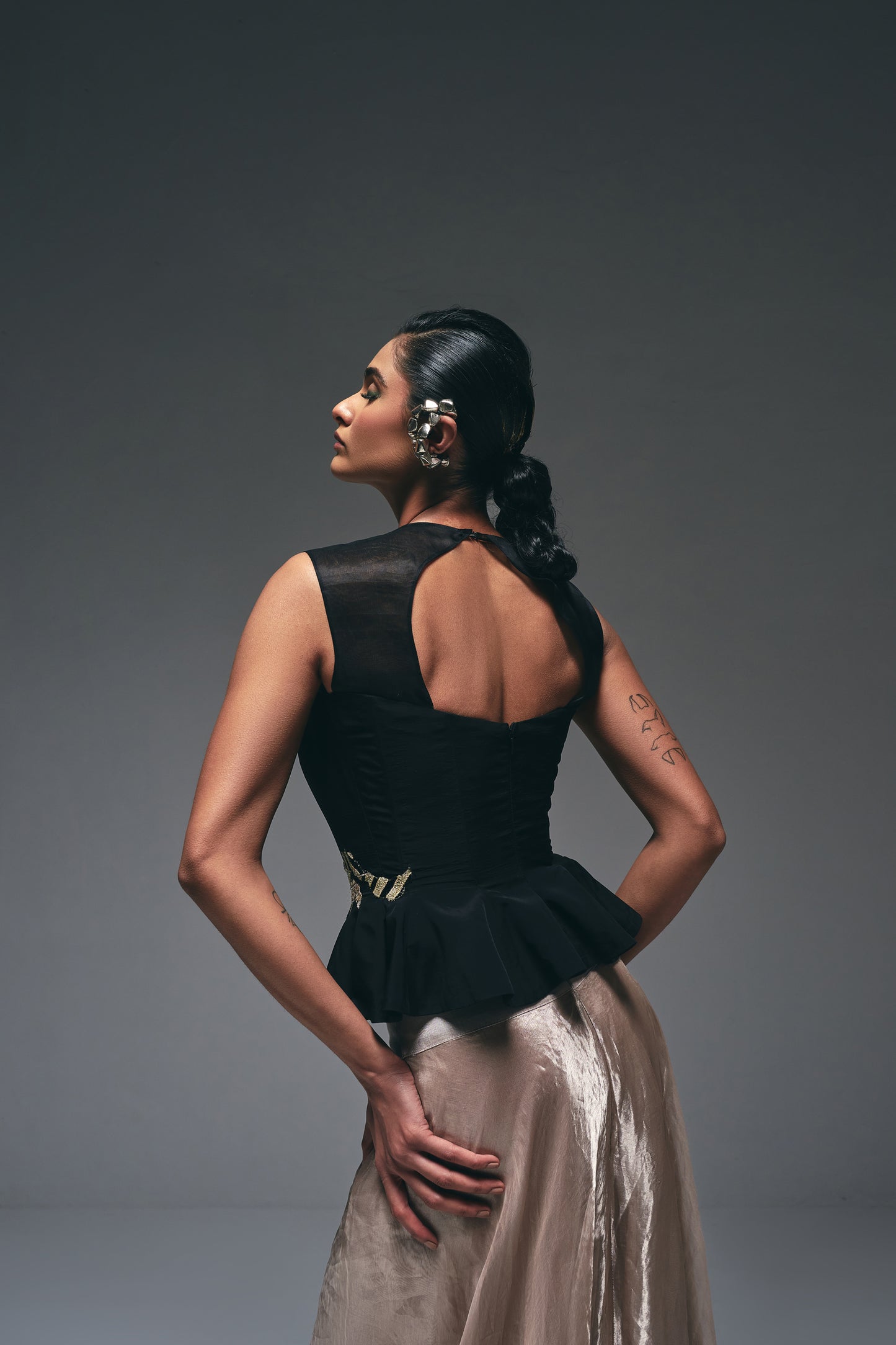 Crepe peplum top paired with a tissue drape skirt,