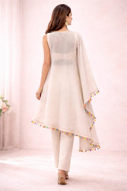 Beige kaftaan with pastel embroidery, flowy fit, and tassel detailing for a subtle festive look.