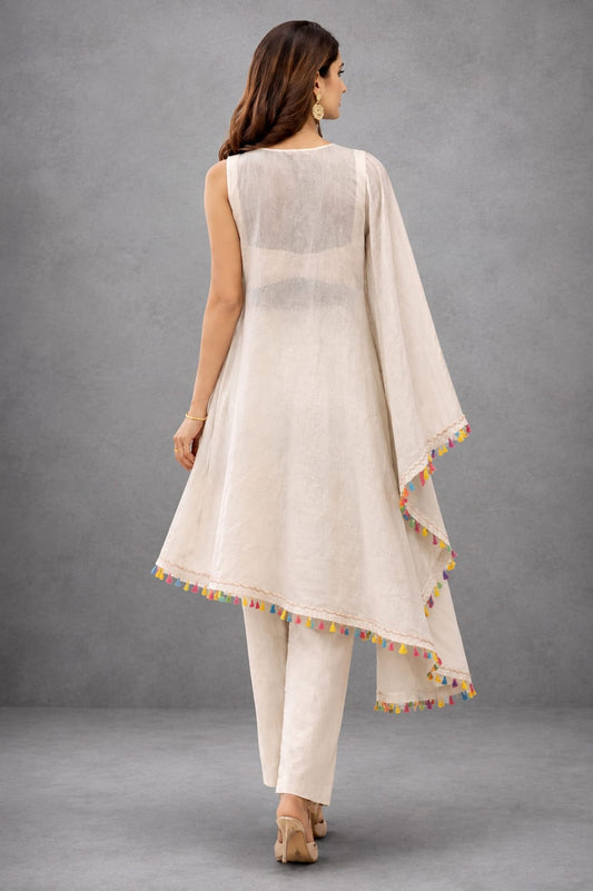 Beige kaftaan with pastel embroidery, flowy fit, and tassel detailing for a subtle festive look.