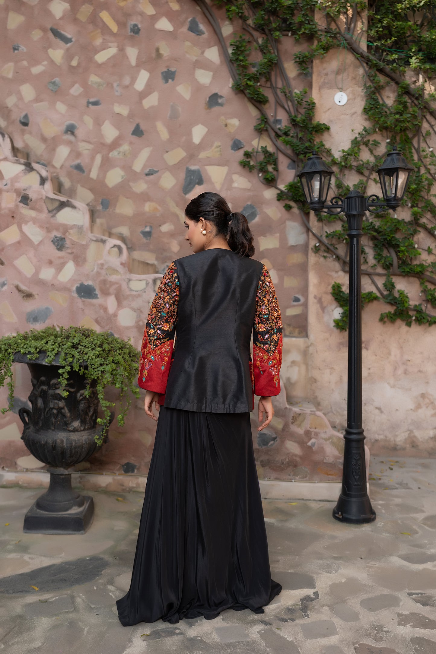 Black embroidered jacket set with bustier and drape skirt.