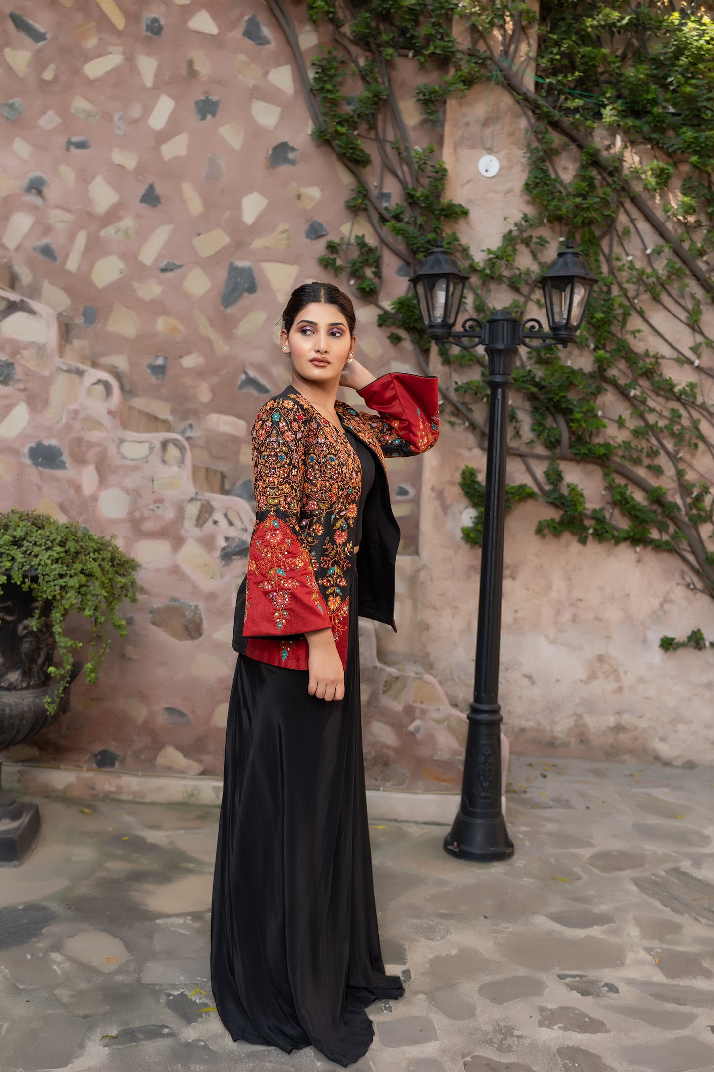 Black embroidered jacket set with bustier and drape skirt.