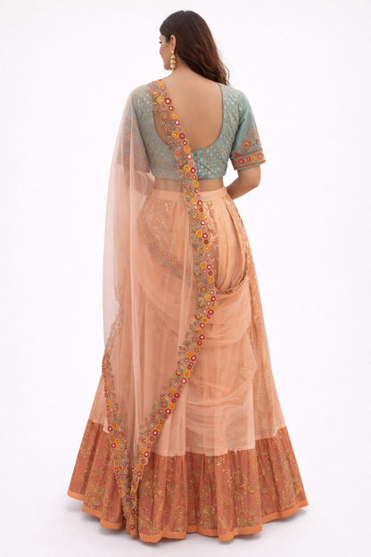 Peach and mint green lehenga saree in organza, silk, and tissue, embellished with thread, mirror, and sequin work.