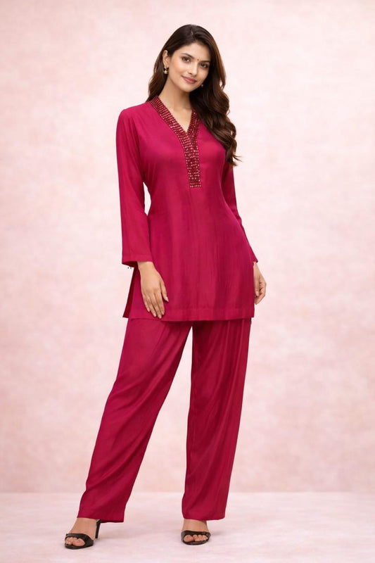 Hot pink cordset with hand work on neckline  of crystals