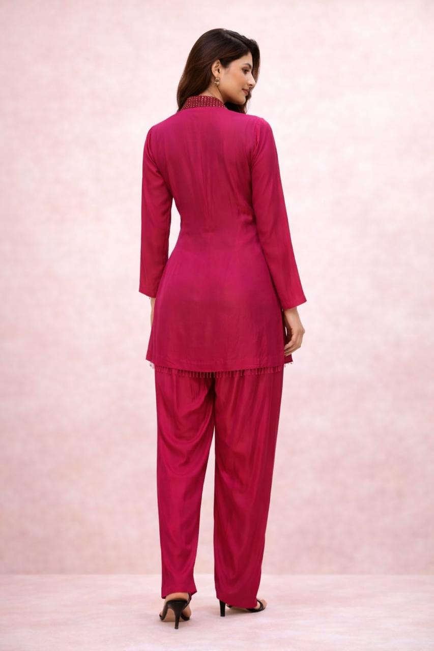 Hot pink cordset with hand work on neckline  of crystals