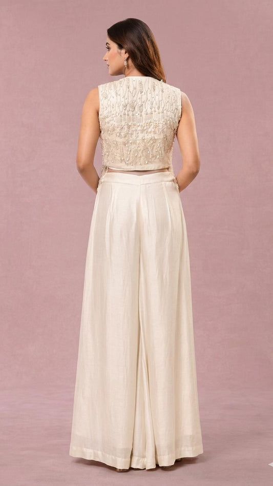 Off white short jacket with long pearl hangings & loose pallazo pants