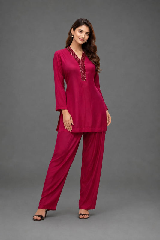 Hot pink cordset with hand work on neckline  of crystals