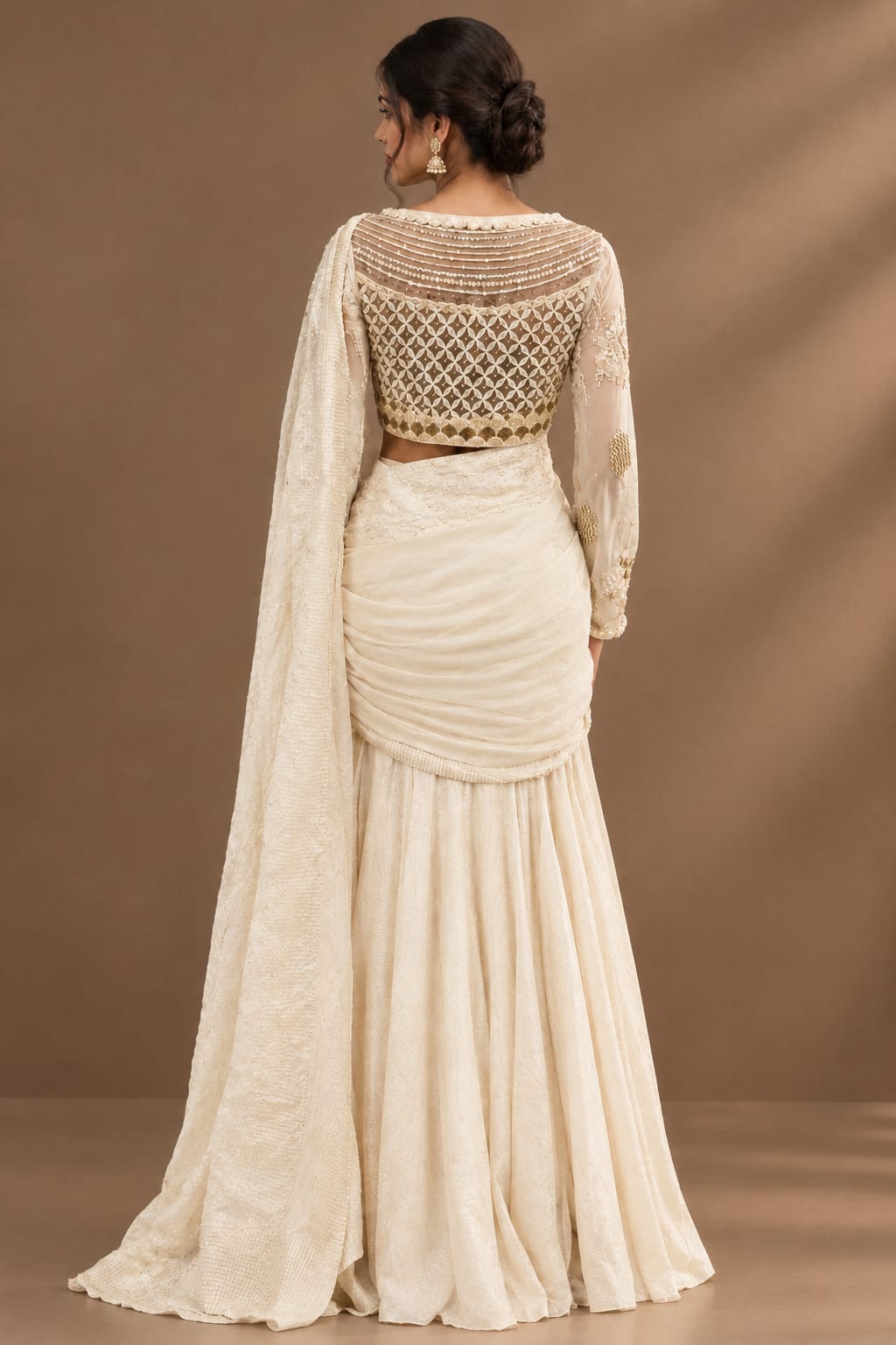 Elegant ivory-white saree featuring delicate pearl, sequin and tonal embroidery.