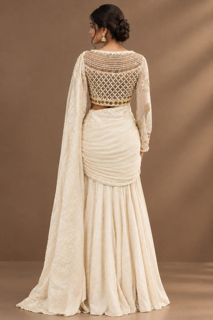 Elegant ivory-white saree featuring delicate pearl, sequin and tonal embroidery.