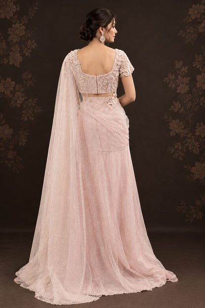 Soft pastel blush-pink lehenga in a delicate, flowy fabric with a subtle net.