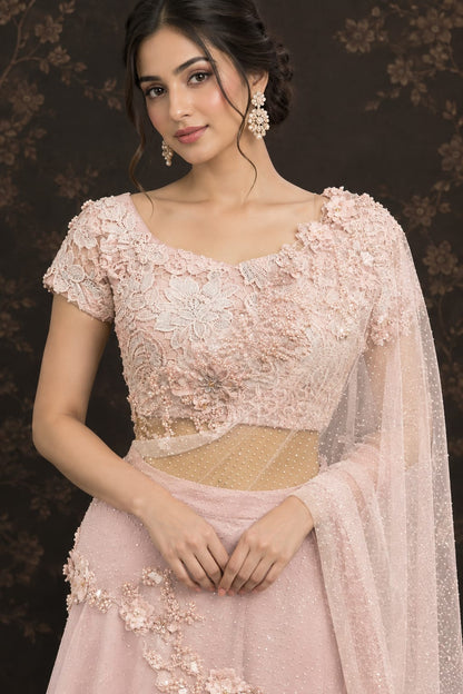 Soft pastel blush-pink lehenga in a delicate, flowy fabric with a subtle net.
