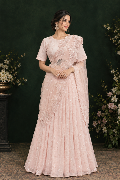 Soft blush pink lehenga set with delicate sequin detailing and fine tonal embroidery.